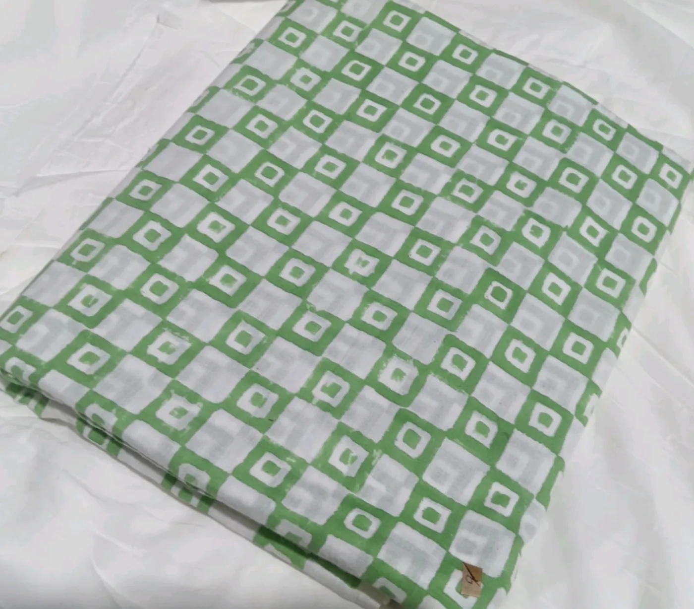 Close-up of Cali Lifestyle sage green hand block-printed 100% cotton fabric