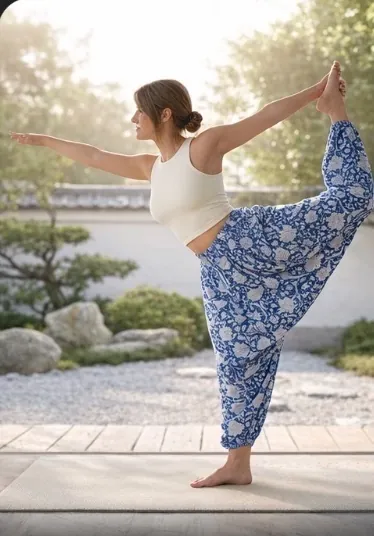 Woman in dancer pose wearing Krishna Blue hand block-printed 100% cotton yoga pants